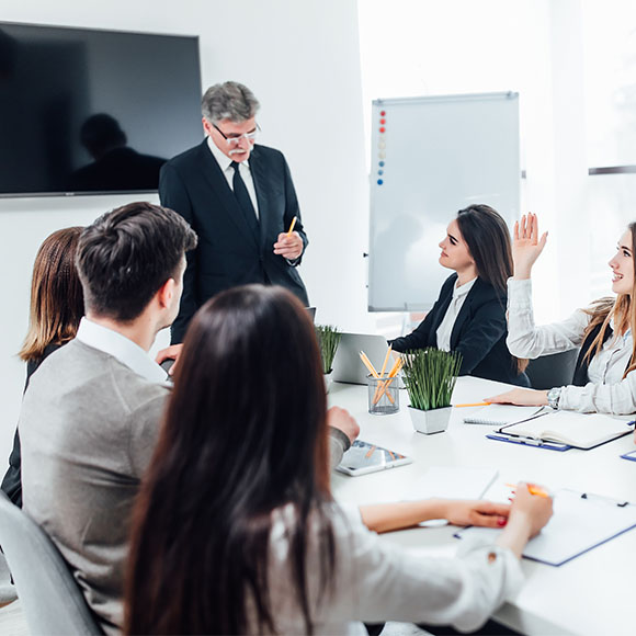 Manager leading an internship briefing with a small team