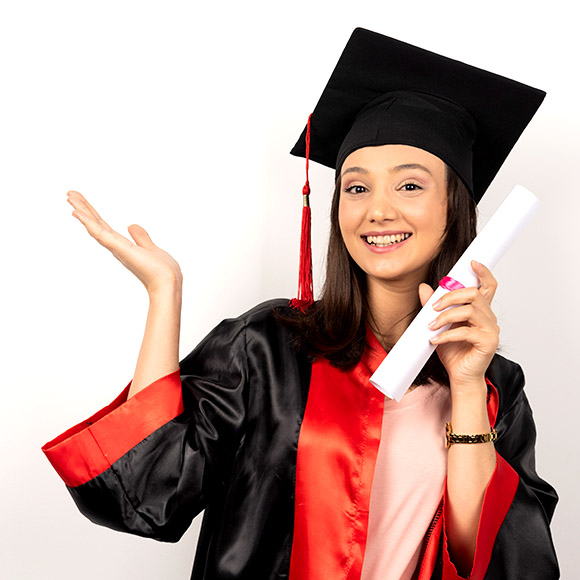 Graduate in cap and gown celebrating with a diploma