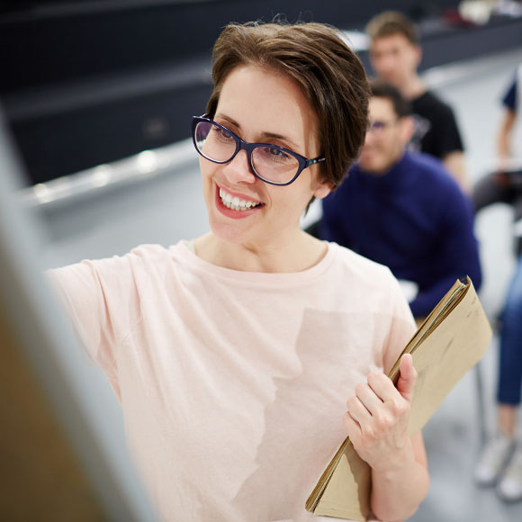 Trainer smiling while leading a group learning session